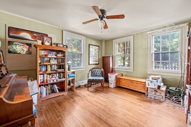 sitting room featuring plenty of natural light, crown molding, light hardwood / wood-style flooring, and ceiling fan