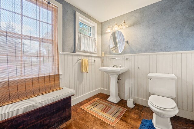 bathroom featuring plenty of natural light, sink, toilet, and hardwood / wood-style floors