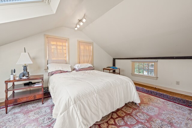 bedroom with light hardwood / wood-style floors and vaulted ceiling