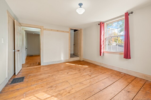 unfurnished bedroom featuring hardwood / wood-style floors