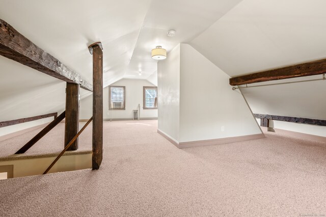 hall with lofted ceiling and carpet