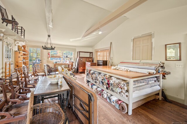 bedroom with dark hardwood / wood-style floors and vaulted ceiling with beams