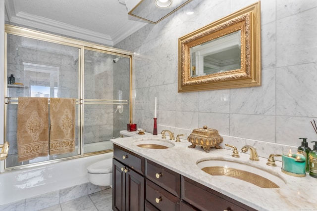 full bathroom featuring vanity, crown molding, toilet, enclosed tub / shower combo, and tile walls