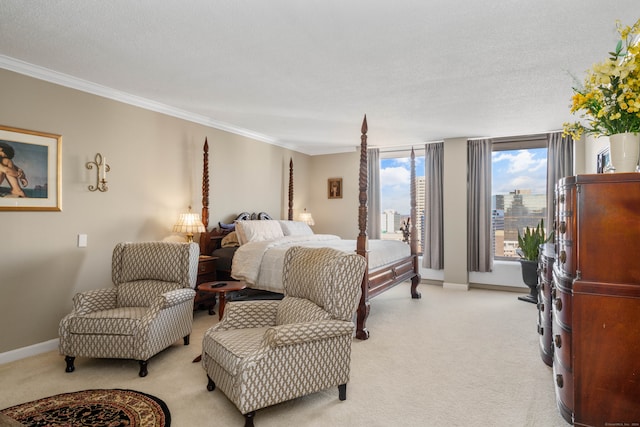 carpeted bedroom with ornamental molding and a textured ceiling