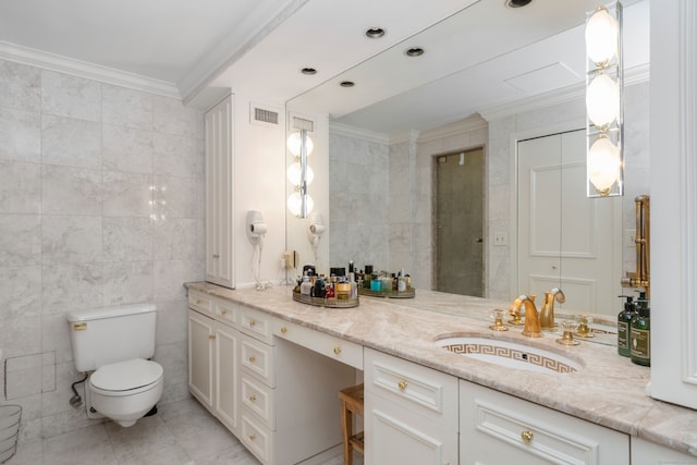 bathroom with crown molding, vanity, and tile walls