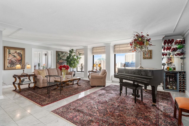 living area with wine cooler, crown molding, ornate columns, and a textured ceiling