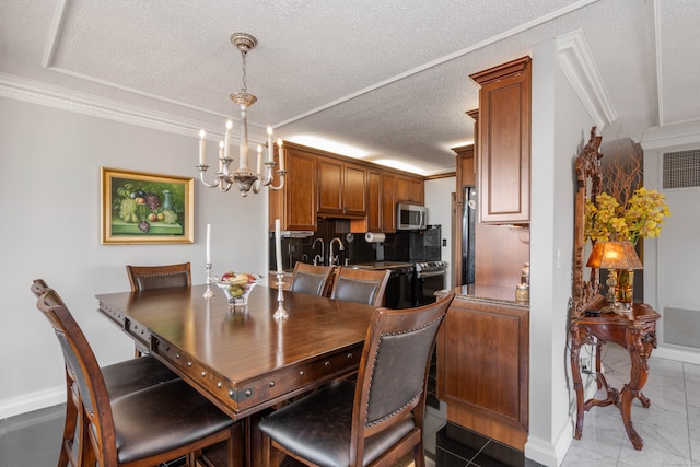 tiled dining room with sink, ornamental molding, a textured ceiling, and a chandelier