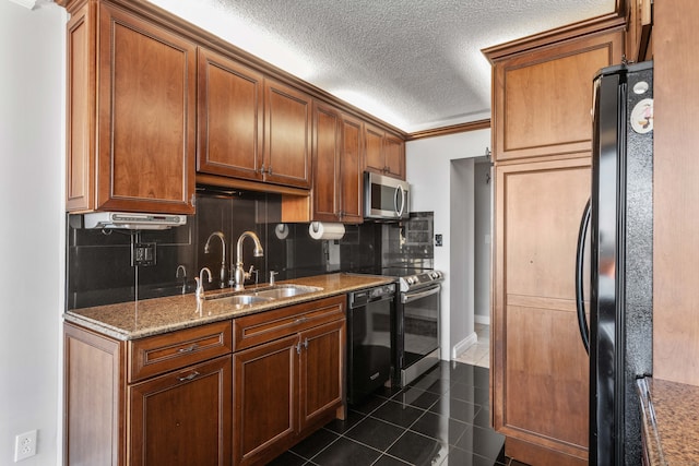 kitchen with stone counters, sink, dark tile patterned floors, backsplash, and black appliances