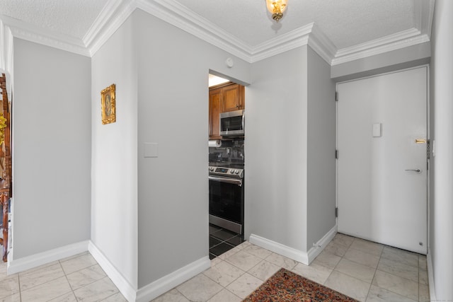 tiled entryway featuring a textured ceiling and ornamental molding