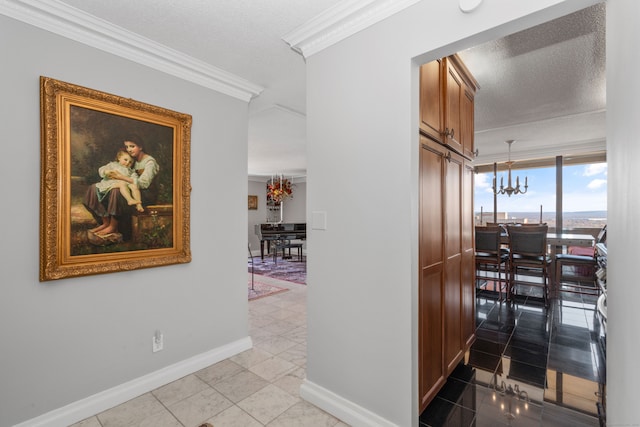 corridor featuring a textured ceiling, a notable chandelier, light tile patterned floors, and crown molding