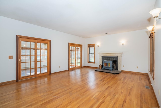 unfurnished living room featuring light hardwood / wood-style flooring and a baseboard heating unit