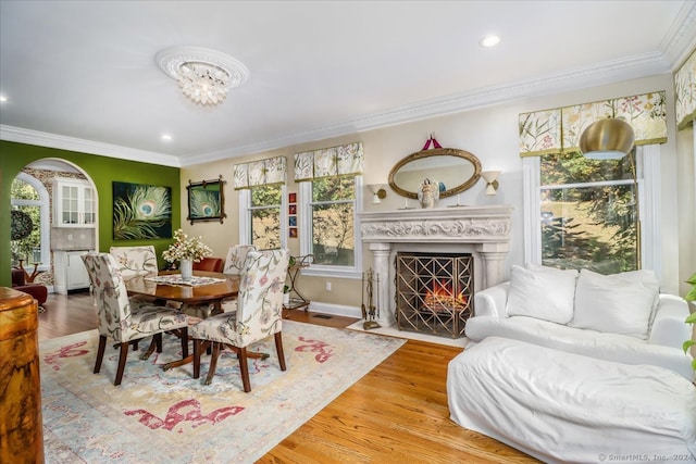 dining space with plenty of natural light, ornamental molding, and hardwood / wood-style flooring