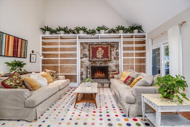 living room with a fireplace, high vaulted ceiling, and hardwood / wood-style floors