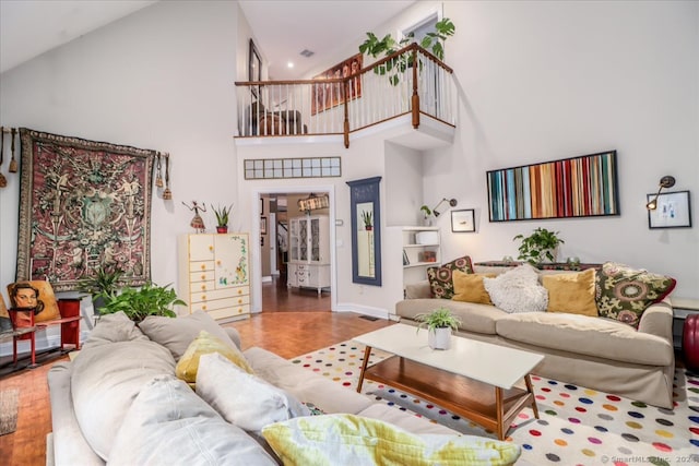 living room featuring wood-type flooring and high vaulted ceiling