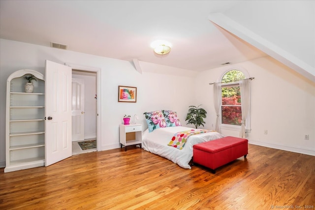 bedroom with hardwood / wood-style flooring