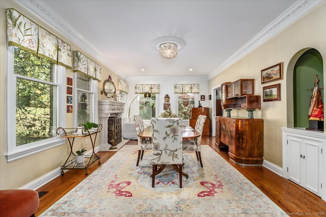 dining area featuring crown molding and dark hardwood / wood-style flooring