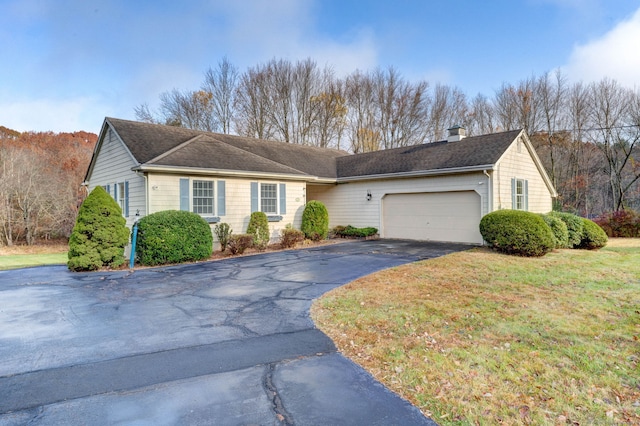 view of front of property with a front yard and a garage