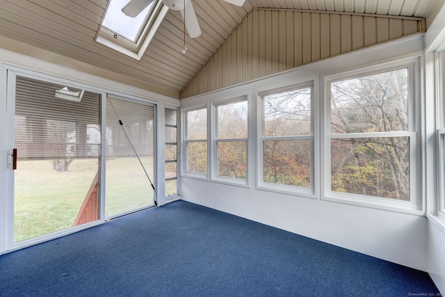 unfurnished sunroom featuring ceiling fan, vaulted ceiling with skylight, and wooden ceiling