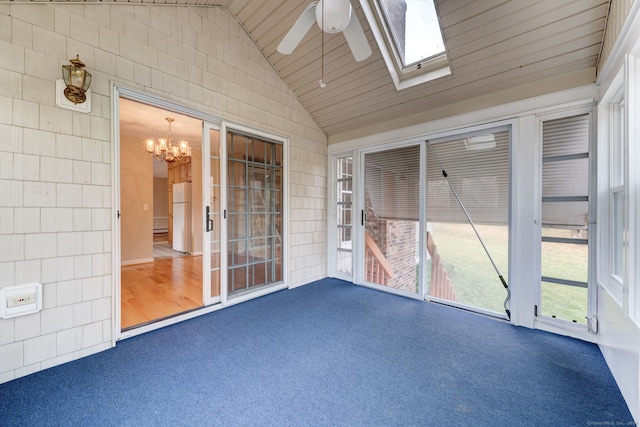 unfurnished sunroom with ceiling fan and vaulted ceiling with skylight