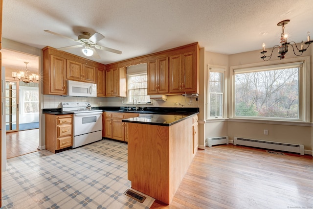 kitchen featuring white appliances, light hardwood / wood-style flooring, a baseboard radiator, and hanging light fixtures