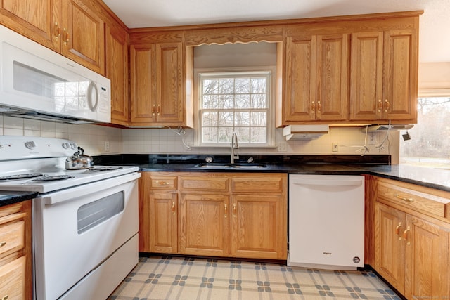 kitchen featuring white appliances, tasteful backsplash, and sink