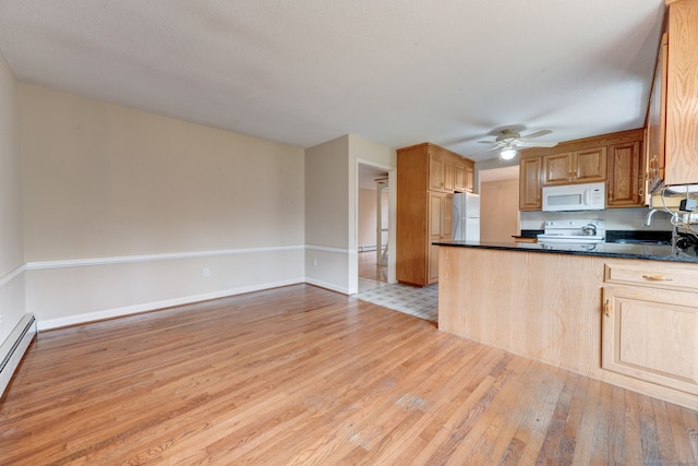 kitchen featuring ceiling fan, light hardwood / wood-style flooring, baseboard heating, sink, and white appliances