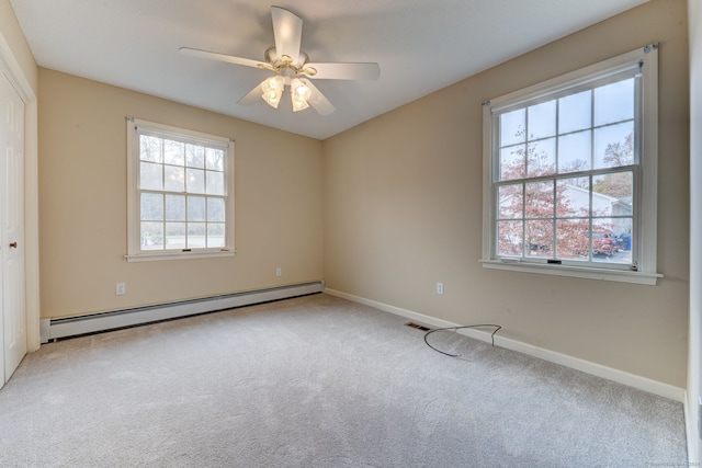 carpeted empty room featuring baseboard heating and ceiling fan