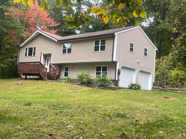 bi-level home with a garage, a wooden deck, and a front lawn