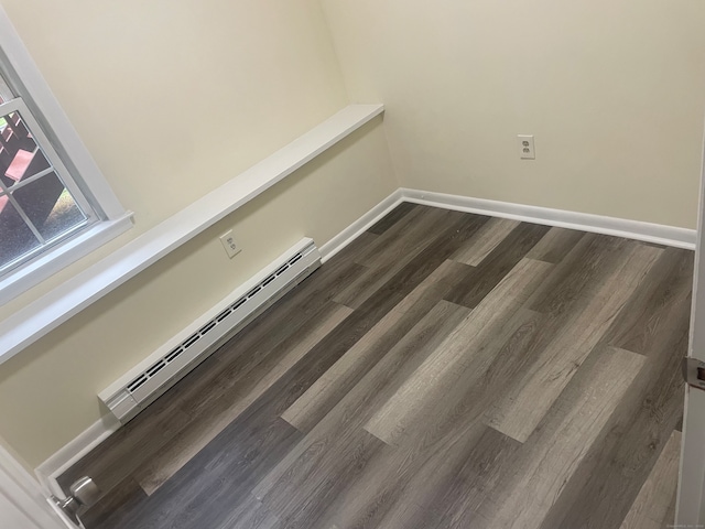 room details featuring wood-type flooring and a baseboard heating unit