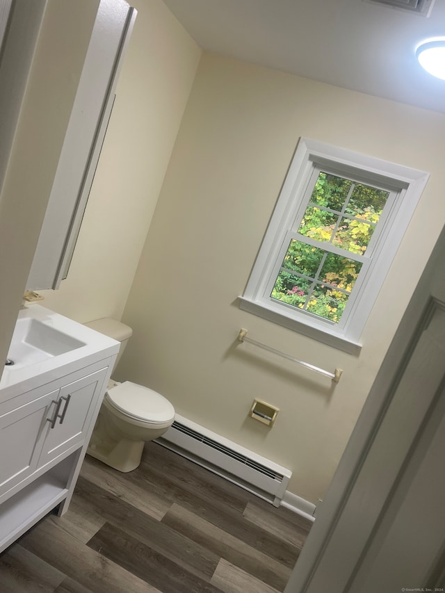 bathroom featuring hardwood / wood-style floors, vanity, a baseboard radiator, and toilet