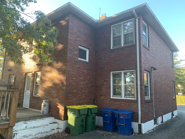 view of side of home with a wooden deck