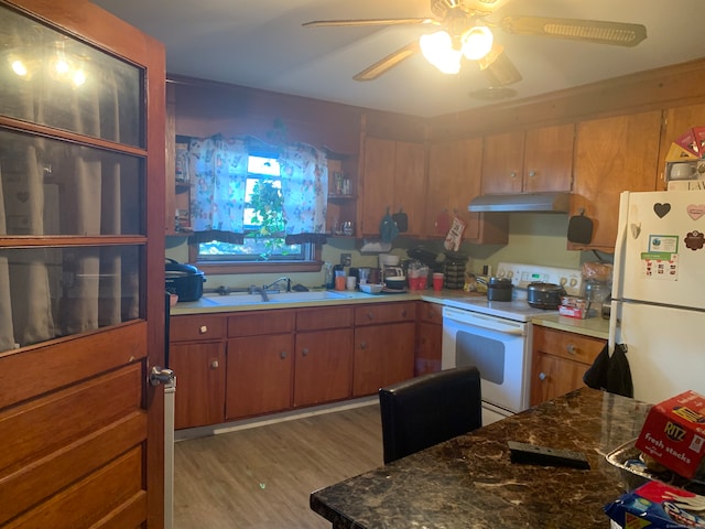 kitchen featuring ceiling fan, white appliances, sink, and light hardwood / wood-style floors