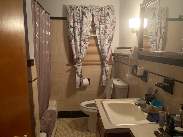 full bathroom with tile patterned flooring, tile walls, vanity, and toilet