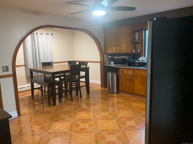 kitchen with stainless steel appliances, baseboard heating, and ceiling fan