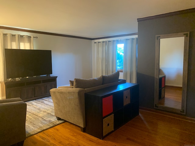 living room with crown molding and hardwood / wood-style floors