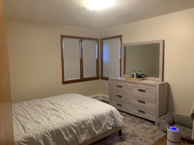 bedroom featuring a baseboard radiator and hardwood / wood-style floors