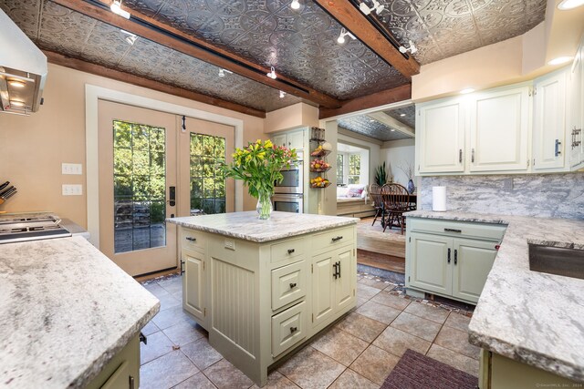 538 Wheelers Pt, Winchester, CT 06098 - kitchen with an ornate ceiling, extractor fan, tasteful backsplash, a center island, and light tile patterned floors