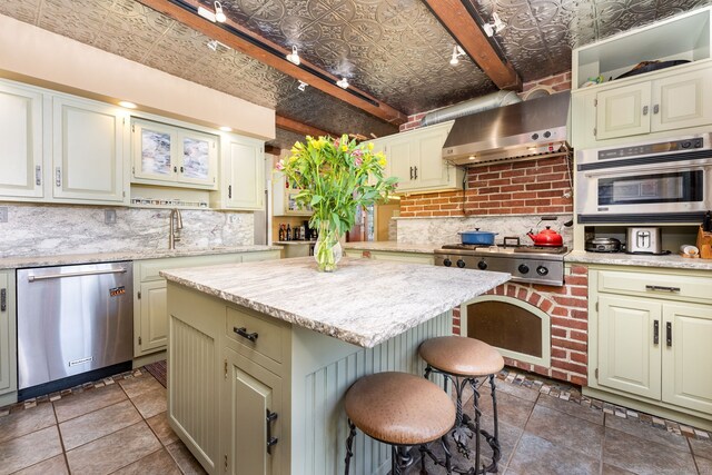 538 Wheelers Pt, Winchester, CT 06098 - kitchen featuring appliances with stainless steel finishes, an ornate ceiling, decorative backsplash, wall chimney range hood, and a breakfast bar area