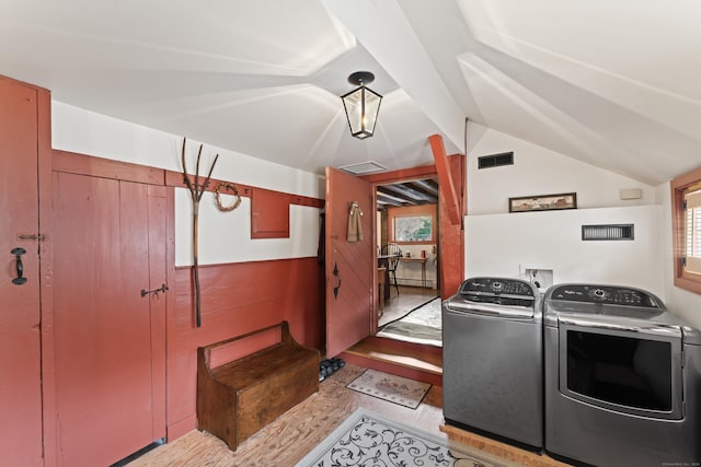 washroom featuring laundry area, separate washer and dryer, visible vents, and wood finished floors