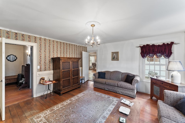 living area with wallpapered walls, a chandelier, and hardwood / wood-style flooring