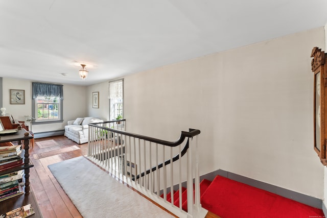 interior space featuring a baseboard heating unit and wood-type flooring