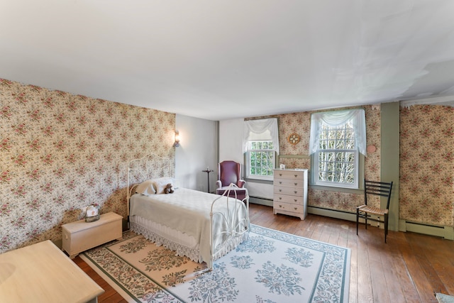 bedroom featuring hardwood / wood-style floors and a baseboard radiator