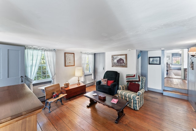 living room with plenty of natural light, hardwood / wood-style floors, and baseboard heating