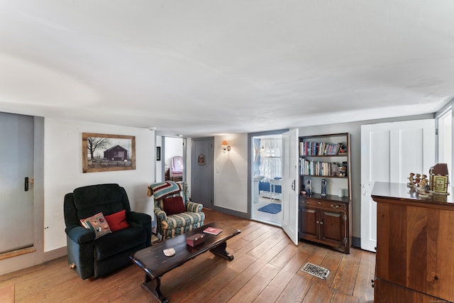 living room with light wood-type flooring and visible vents