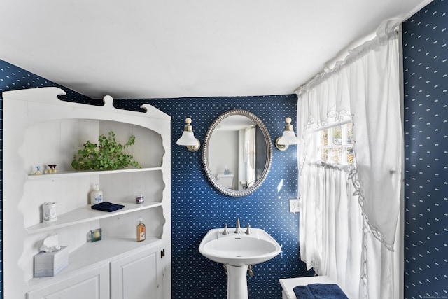 bathroom featuring wallpapered walls