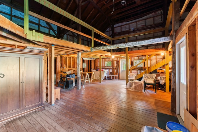 misc room featuring wood-type flooring and high vaulted ceiling