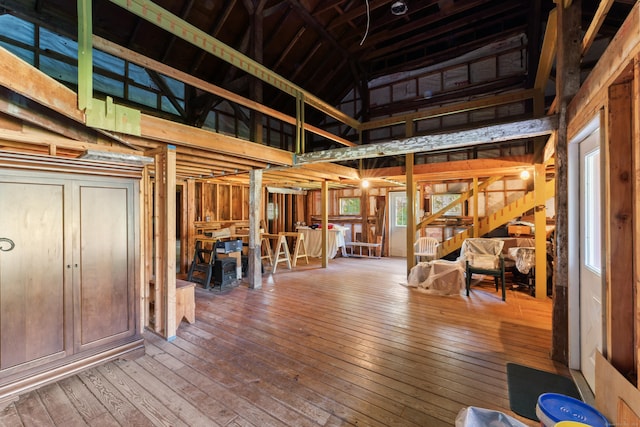 interior space with hardwood / wood-style floors and high vaulted ceiling
