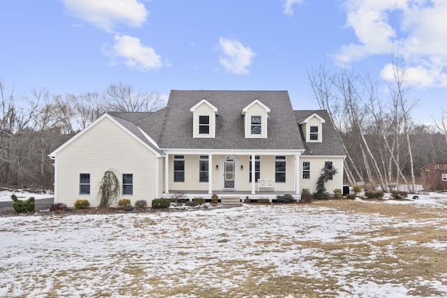 cape cod house featuring a porch