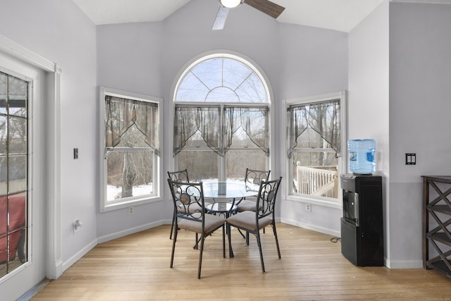 dining room with vaulted ceiling, ceiling fan, and light hardwood / wood-style floors