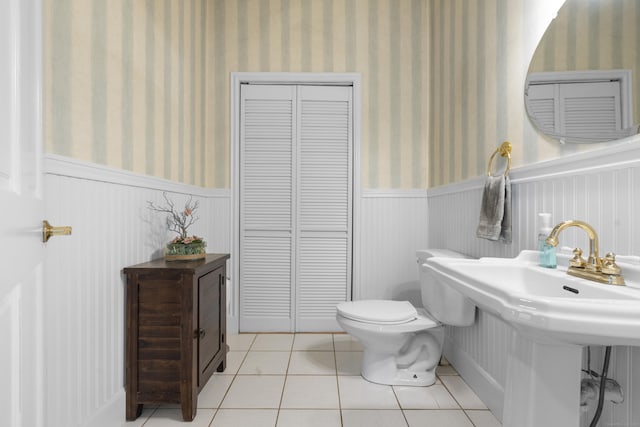 bathroom with tile patterned flooring, sink, and toilet